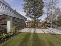 an apartment with a driveway in the front yard and two car parking spaces in front of it