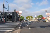 a crosswalk that runs on the side of the street in front of a building