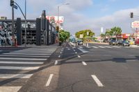 a crosswalk that runs on the side of the street in front of a building