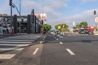 a crosswalk that runs on the side of the street in front of a building