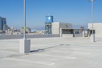 there is a view of the city from this rooftop parking lot area, where the city skyline can be seen