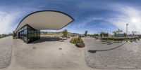 a fisheye lens is shown showing an exterior of the school with a circular courtyard