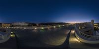 view of a skateboard park with a night sky behind it and the sun low lighting on it