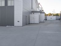 this is an image of a storage shed area with metal doors, a fire hydrant and a ladder