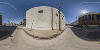 two circular photos showing a street view, and a man riding a skateboard down the side