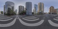 an intersection with buildings behind and empty road in front of it's corner, and with a view of the sky