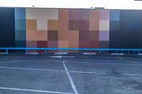 this photo shows some parking lots with paint blockings in it's area, including a giant painted mural