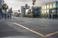 there are cars on a street at an intersection under a cloudy sky on a sunny day