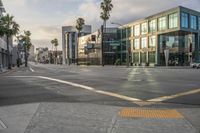 there are cars on a street at an intersection under a cloudy sky on a sunny day