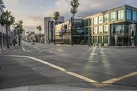 there are cars on a street at an intersection under a cloudy sky on a sunny day