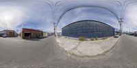 two circular spherical panoramas with the street in the foreground as well as buildings and electrical wires