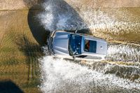 a boat is driving through the shallow water, and its wake is making it's way through