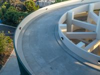 an aerial view of the skateboarder on top of a ramp in front of a residential building