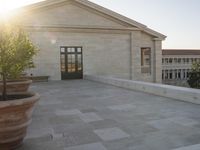 there is a building with an old stone entrance and benches in front of it at sunset