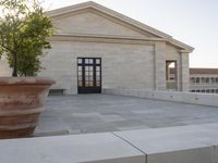 there is a building with an old stone entrance and benches in front of it at sunset