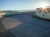 a person riding a skateboard up the side of a ramp at the end of a road