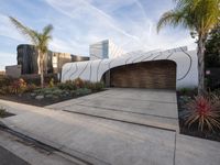 the large garage features concrete and concrete pavers, as well as two wooden panels