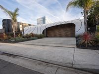 the large garage features concrete and concrete pavers, as well as two wooden panels