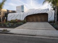 the large garage features concrete and concrete pavers, as well as two wooden panels