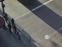 a blurry view of the traffic light on the street, and sign by the sidewalk