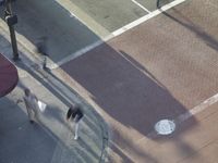 a blurry view of the traffic light on the street, and sign by the sidewalk