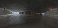 a fish eye shot of a tunnel with the train coming down and people walking on the sidewalk below