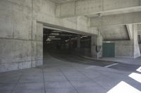 concrete structure, with floor, ramp and parking lot and some windows and doors on either side