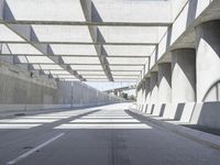 the underpass on a bridge runs along the roadway near an empty parking lot area