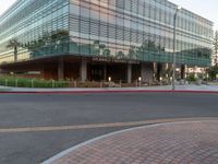 two grey blocks sitting next to a tall building on a sidewalk in front of grass