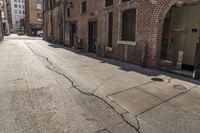 this is an empty street in the city with no cars and there is a man walking behind it