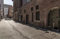 this is an empty street in the city with no cars and there is a man walking behind it