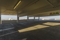 an empty parking garage in a big area with lots of light coming in from the window