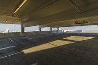 an empty parking garage in a big area with lots of light coming in from the window