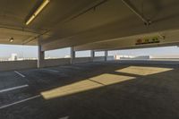 an empty parking garage in a big area with lots of light coming in from the window