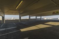 an empty parking garage in a big area with lots of light coming in from the window