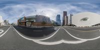 a picture of a street view taken from a 360 - angle view lens with buildings in the background