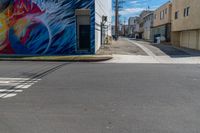 the side of the building is a painted mural depicting a man with a surfboard