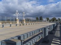 the railing is made of cement and has been replaced to match the concrete poles, making it stand out