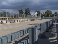 the railing is made of cement and has been replaced to match the concrete poles, making it stand out