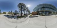 fisheye lens photo of exterior of a modern building with many windows, some of which is half - empty