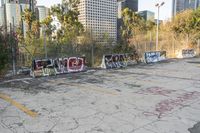 graffiti covers the parking lot at an urban city park, which is vacant for many years