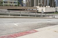 an empty city street with a street sign and a sidewalk with graffiti on it that says'don't waste the city trash '