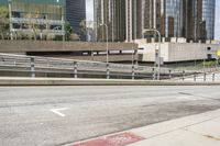 an empty city street with a street sign and a sidewalk with graffiti on it that says'don't waste the city trash '