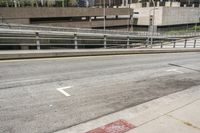 an empty city street with a street sign and a sidewalk with graffiti on it that says'don't waste the city trash '