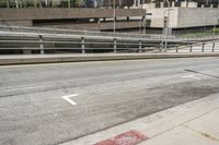 an empty city street with a street sign and a sidewalk with graffiti on it that says'don't waste the city trash '