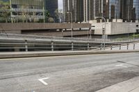 an empty city street with a street sign and a sidewalk with graffiti on it that says'don't waste the city trash '