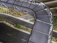 a view of a road and an overpass with traffic passing through it by buildings