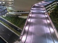 a view of a road and an overpass with traffic passing through it by buildings