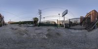 360 - view of the camera, focusing one person and an empty parking lot in front of a gate