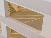 a view of the top of the staircase through an atrium door from above, looking down